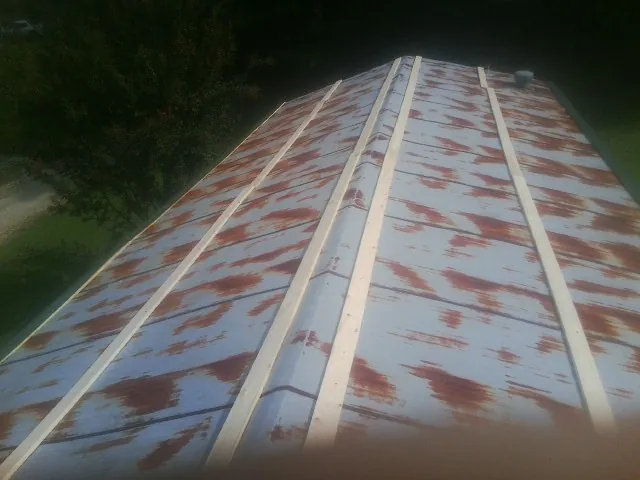 Rusted metal roof panels with new wood purlins before replacement — Storm Damage Roof Repair in Chilhowee by Roofing Brothers