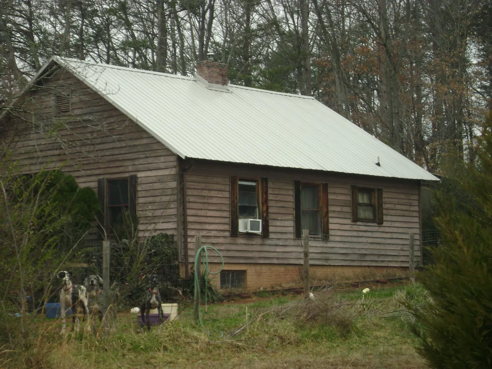 White metal roof on an old wood sided farmhouse, from a Metal Roof Installation job in Chilhowee